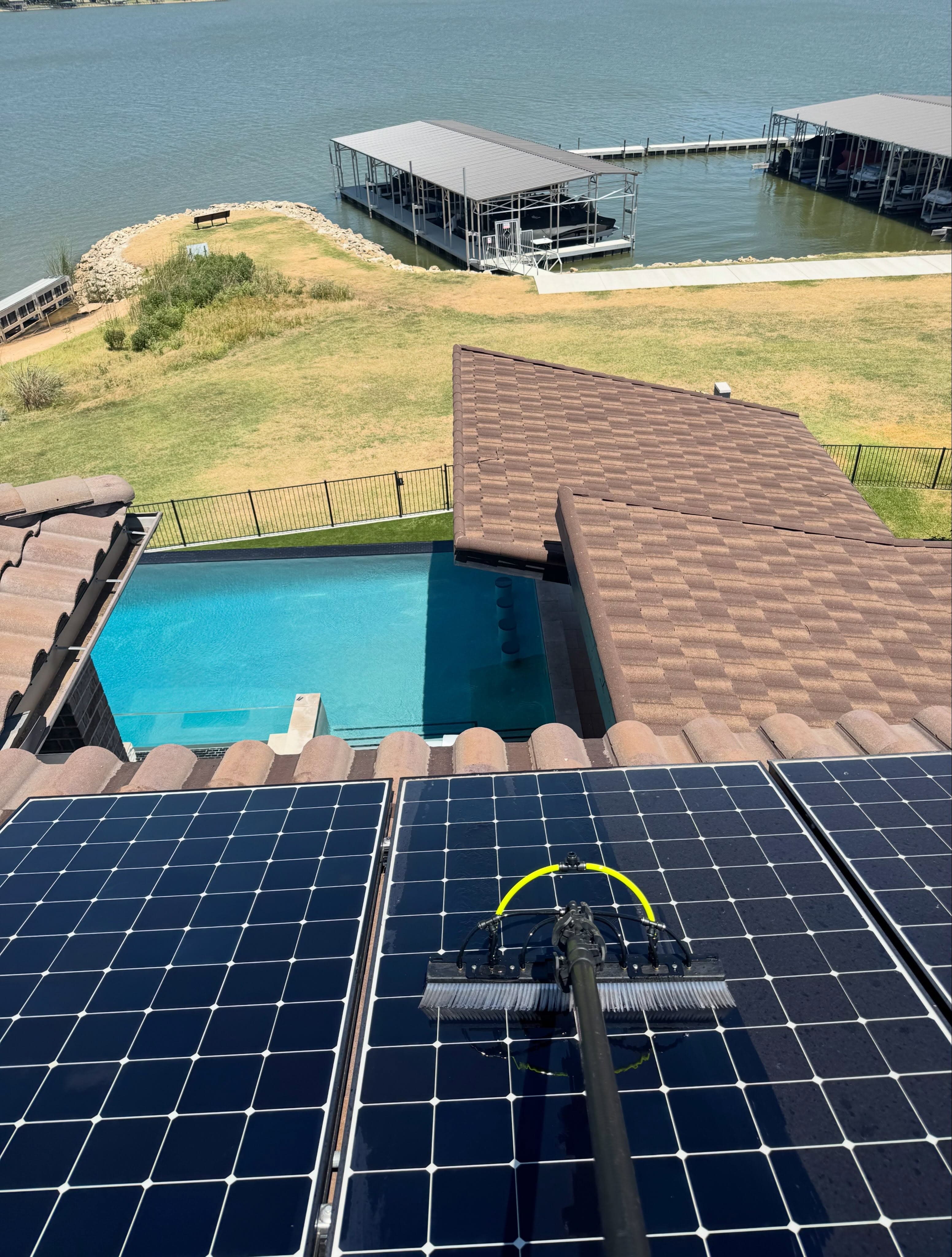 Close-up of solar panel being cleaned with brush